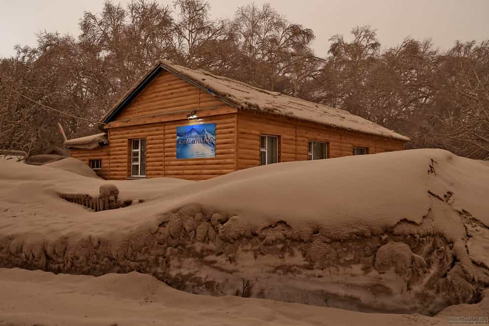 Volcanic ash covers the ground and houses after the Shiveluch volcano’s eruption in Klyuchi village on the Kamchatka Peninsula in Russia (Russian Academy of Sciences’ Volcanology Institute via AP)