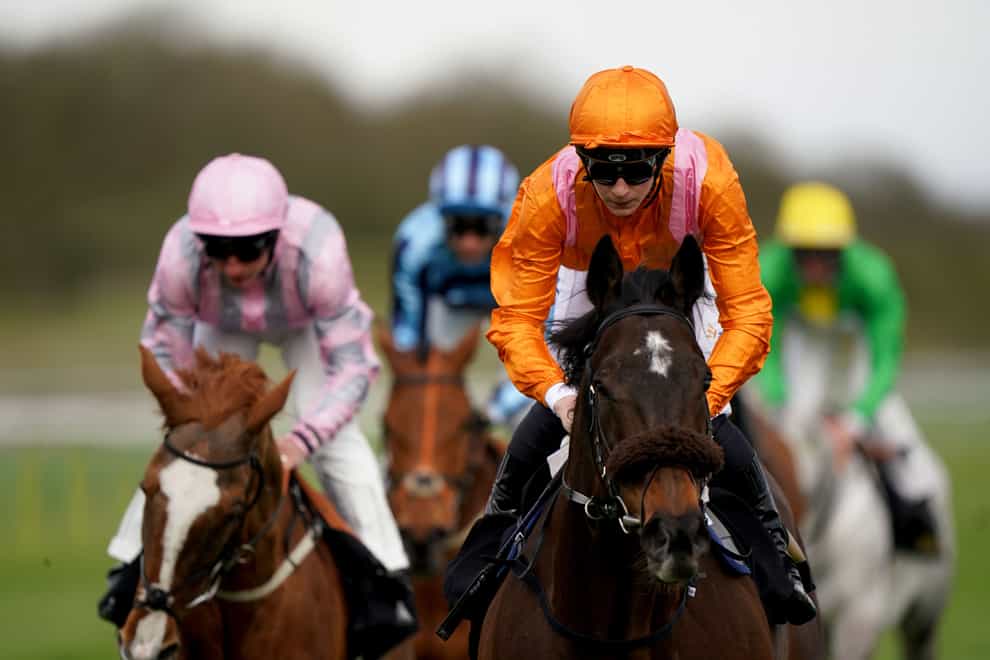 Rajinsky and Harry Davies (orange) coming home to win the Barry Hills Further Flight Stakes at Nottingham (Joe Giddens/PA)