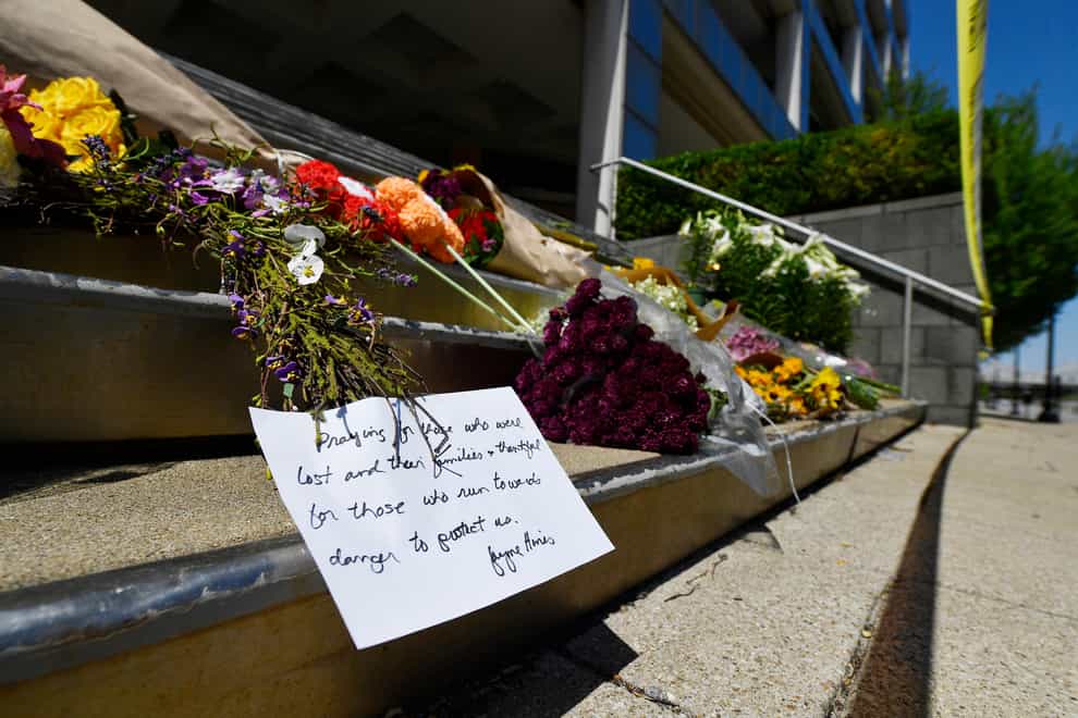 Flowers and a message of hope sit on the steps of the Old National Bank in Louisville, Ky., Tuesday, April 11, 2023. On Monday, a shooting at the bank located in downtown Louisville killed several people and wounded others. (AP Photo/Timothy D. Easley)