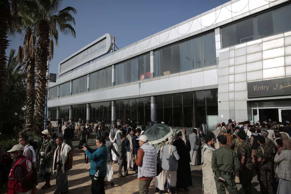 Yemenis gather at the airport ahead of a prisoners exchange in Sanaa (Hani Mohammed/AP)
