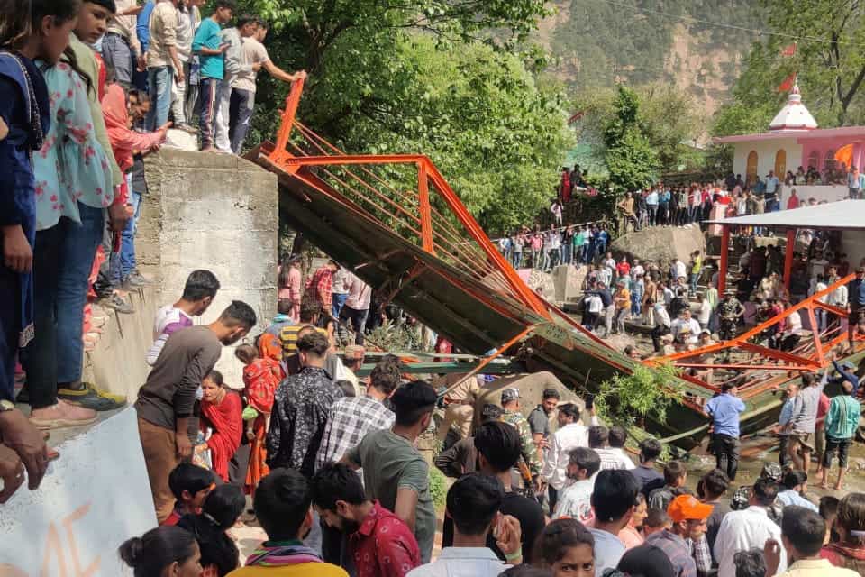 People crowd near the steel footbridge which collapsed (AP)