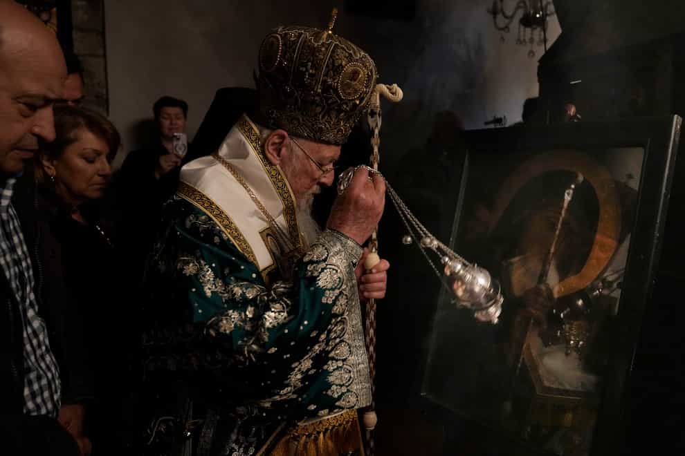 Ecumenical Patriarch Bartholomew I, center, the spiritual leader of the world’s Orthodox Christians, conducts a Good Friday Mass at the Church of the Annunciation in the island of Gokceada, Turkey, known as Imvros in Greek (Khalil Hamra/AP/PA)