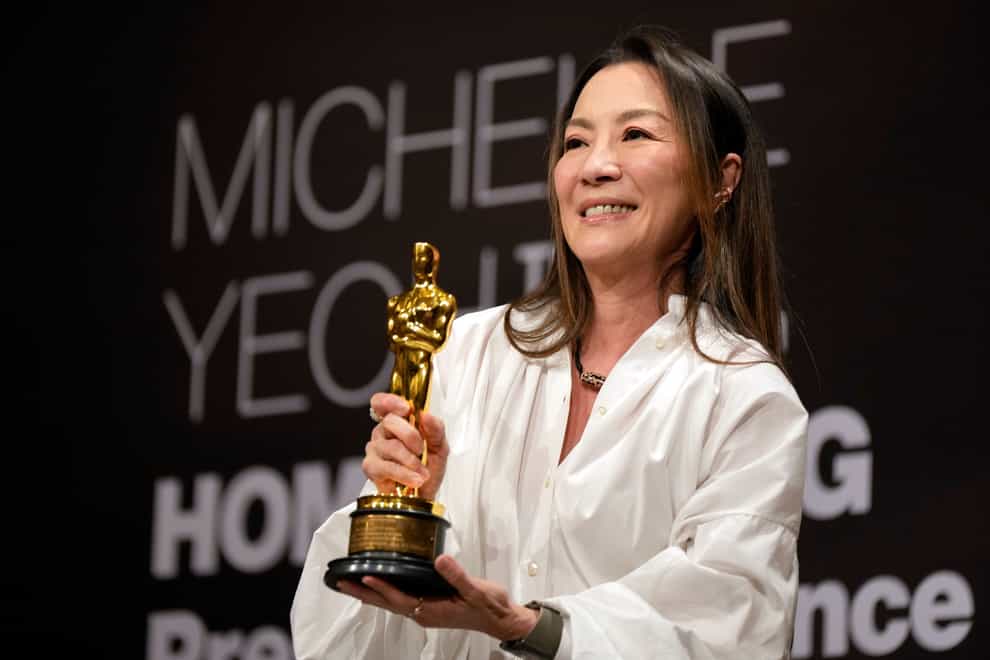 Malaysian actress Michelle Yeoh showed off the Oscar statuette during a press conference in Kuala Lumpur (Vincent Thian/AP)