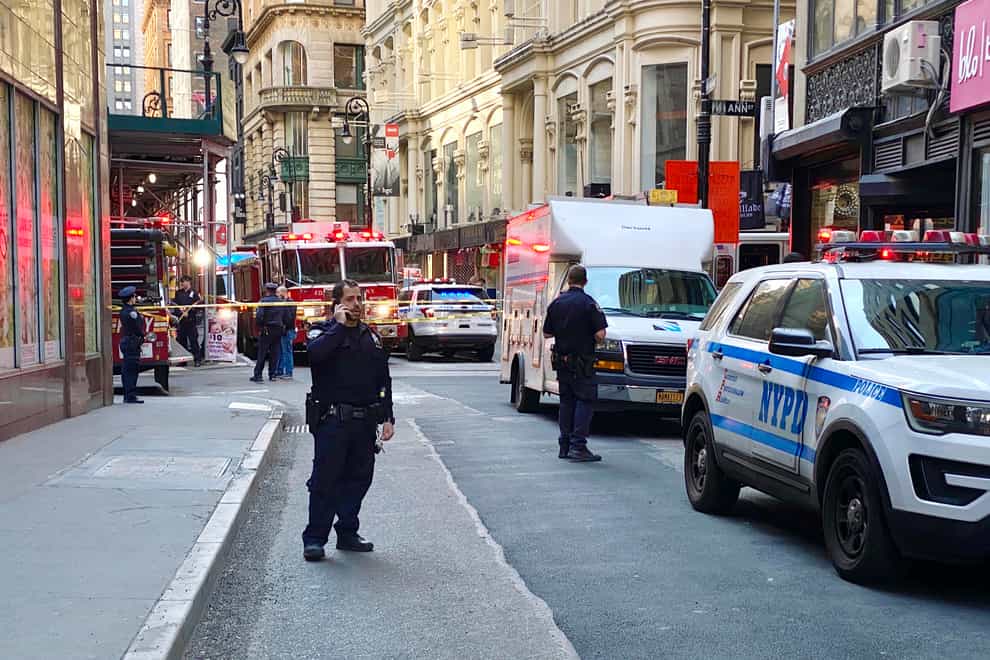 New York City Police and Fire Department personnel cordon off an area in New York’s Financial District near the site of a partially collapsed parking garage (Julie Jacobson/AP/PA)