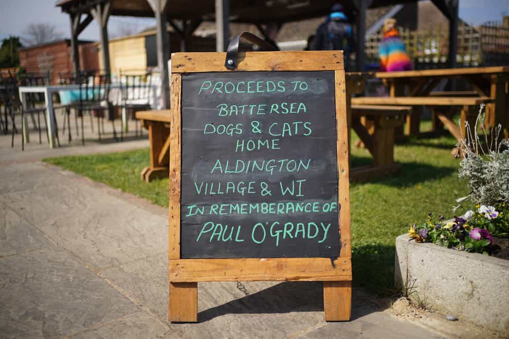 A sign outside the Walnut Tree Pub in Aldington, Kent, ahead of the cortege for Paul O’Grady travelling past on the way to his funeral at St Rumwold’s Church (Yui Mok/PA)