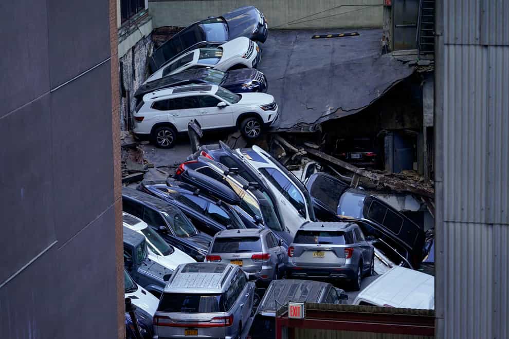 Cars are seen piled on top of each other at the collapsed parking garage (Mary Altaffer/AP)