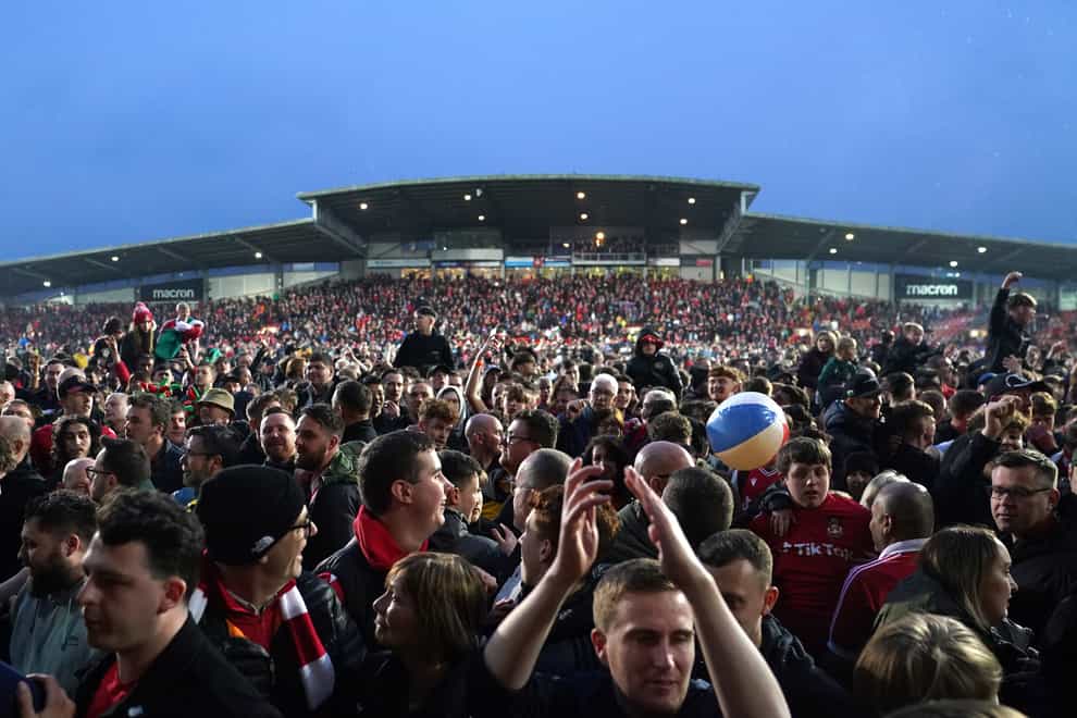 Wrexham fans celebrated promotion with a pitch invasion (Martin Rickett/PA)