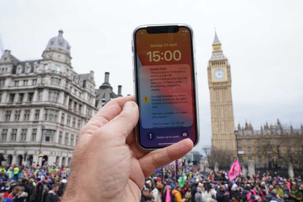 A test of a new public alert system emitting a loud alarm on a mobile phone in Westminster on Sunday (Stefan Rousseau/PA)