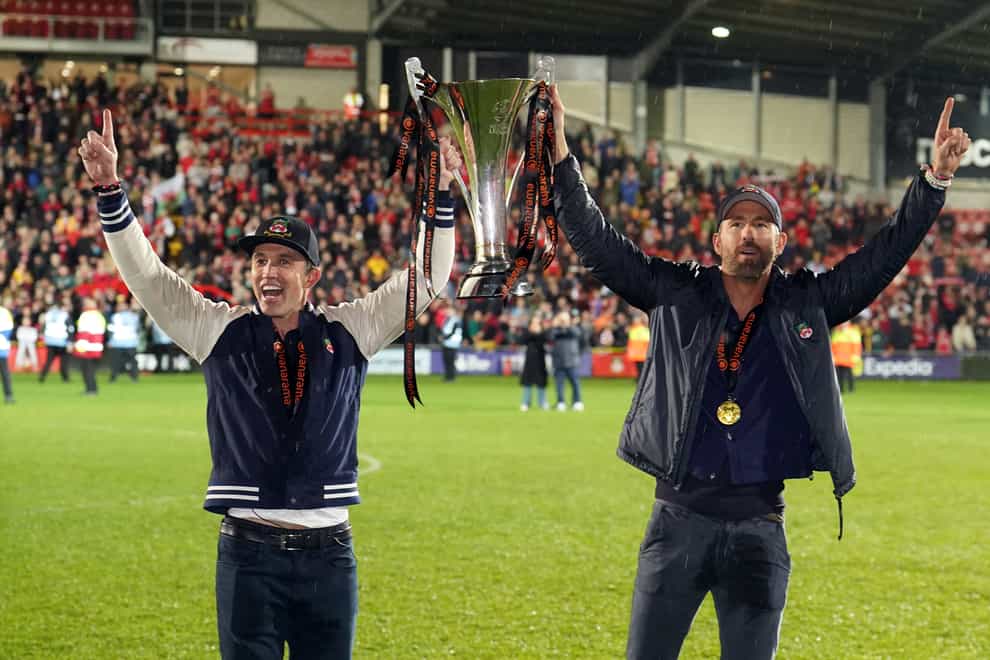 Wrexham co-owners Rob McElhenney and Ryan Reynolds celebrate promotion (Martin Rickett/PA).