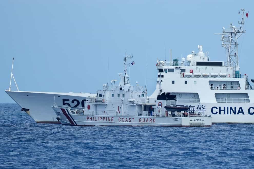 A Chinese coastguard ship blocks Philippine coastguard boat BRP Malapascua (Aaron Favila/AP)