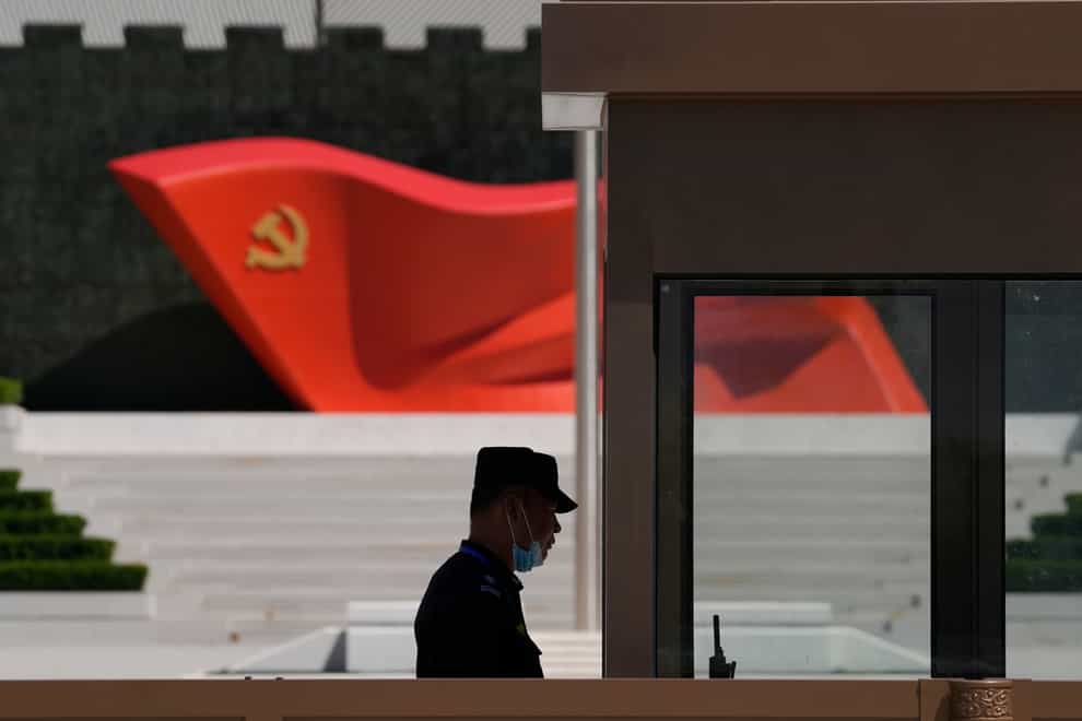 A security guard stands near a sculpture of the Chinese Communist Party flag at the Museum of the Communist Party of China in Beijing (Ng Han Guan/AP)