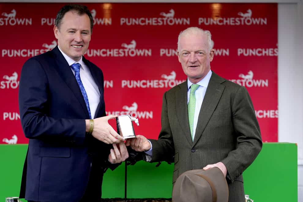 Trainer Willie Mullins is presented with an award by Minister for Agriculture, Food and the Marine of Ireland Charlie McConalogue during day five of the Punchestown Festival at Punchestown Racecourse in County Kildare, Ireland. Picture date: Saturday April 29, 2023.