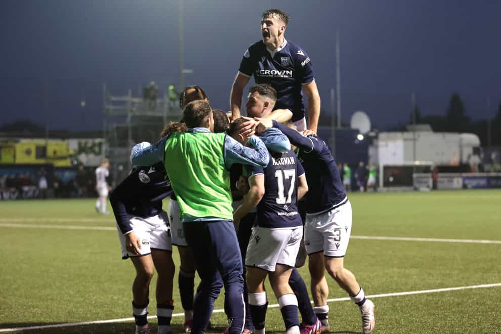 Dundee players celebrate their fifth goal (Steve Welsh/PA)