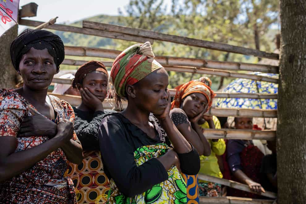 Women react as villagers gather to identify bodies (Moses Sawasawa/AP)