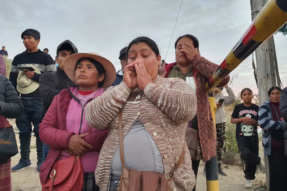 Relatives of trapped miners wait outside the SERMIGOLD mine in Arequipa, Peru (Fernando Mojito/AP)