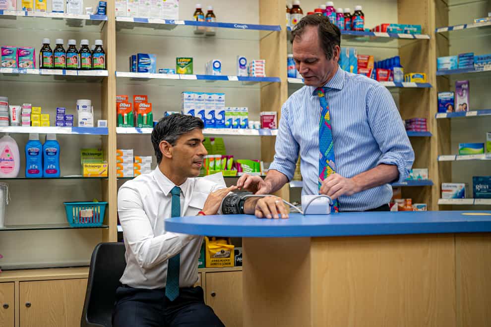 Prime Minister Rishi Sunak has his blood pressure checked by pharmacist Peter Baillie (Ben Birchall/PA)