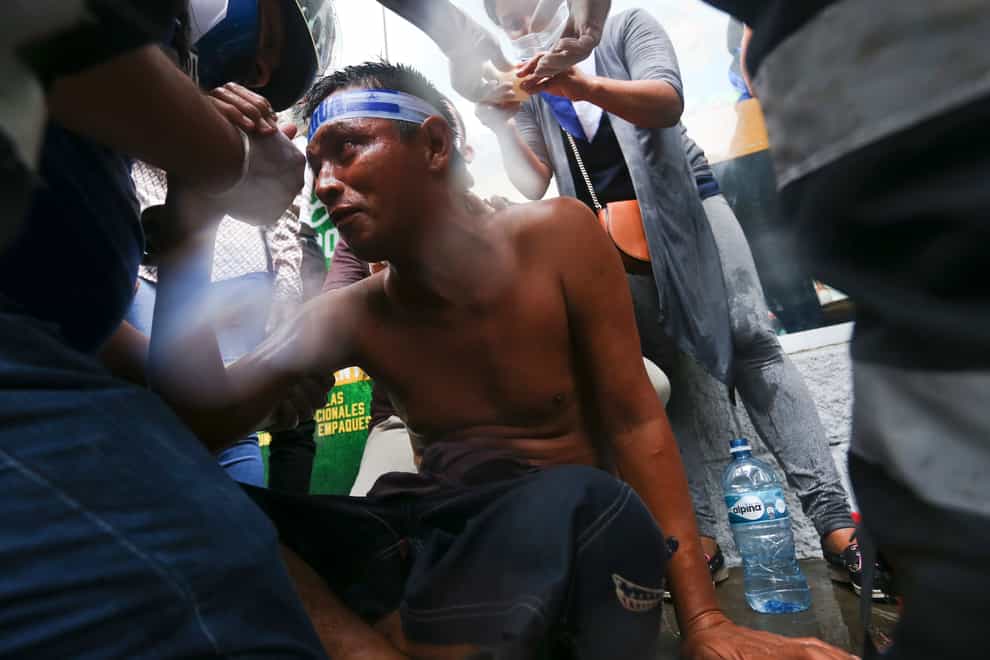 An injured demonstrator receives first aid after being injured by a shotgun blast during clashes with the police, as he was protesting against Nicaragua’s President Daniel Ortega, in Managua, Nicaragua, May 28, 2018. Nicaragua’s parliament closed the Nicaraguan Red Cross on Wednesday, May 10, 2023 (Esteban Felix/AP/PA)