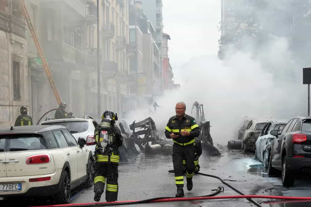 Firefighters work to extinguish the fire (Luca Bruno/AP)