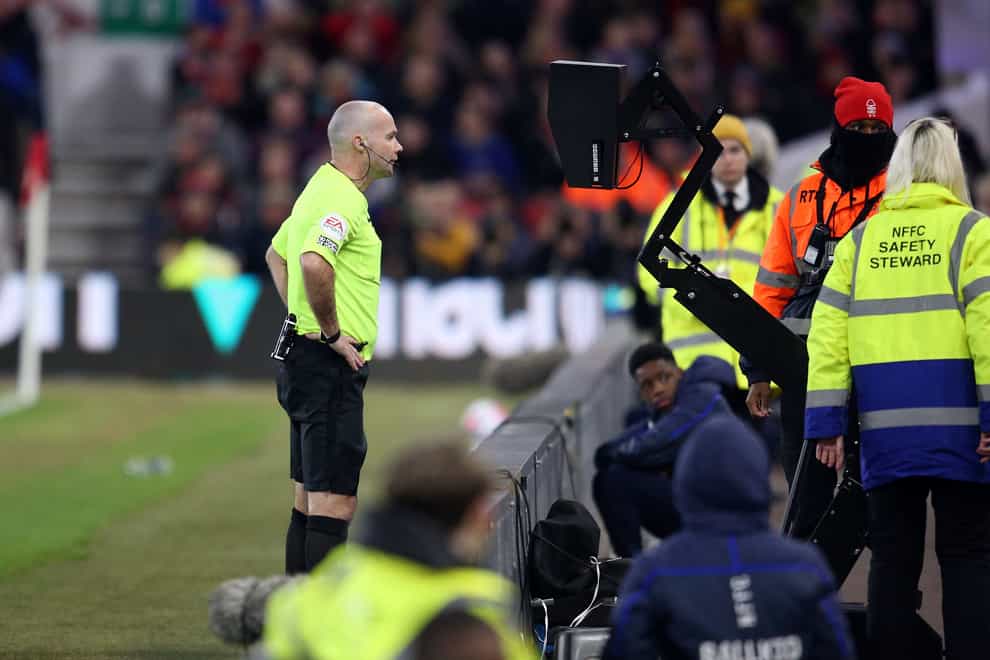 Referee Paul Tierney checks the pitchside monitor during the Nottingham Forest v Newcastle match in March (Nigel French/PA)