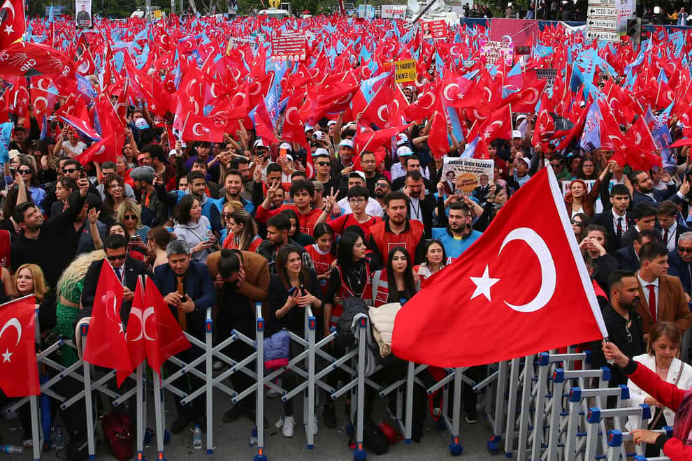 Supporters of presidential candidate Kemal Kilicdaroglu wave Turkish flags during an election campaign rally in Ankara (Ali Unal/AP)