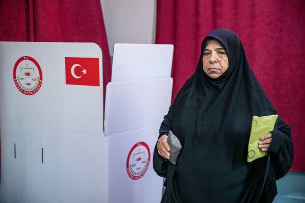A woman votes at a polling station in Diyarbakir (Metin Yoksu/AP)