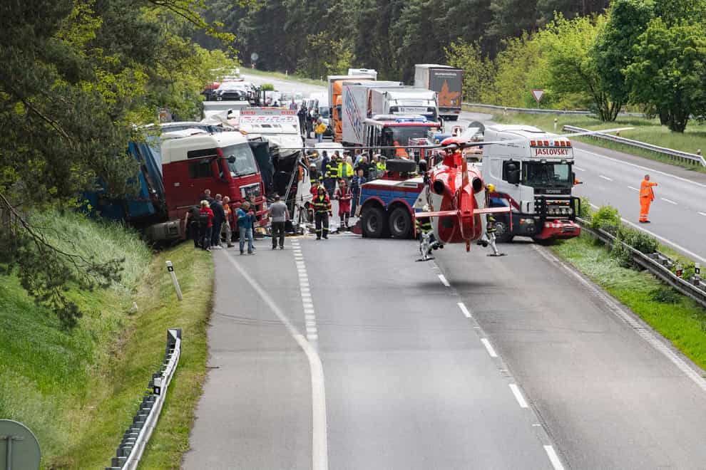 Police and ambulance crews attend the scene of a crash on the D2 highway (Michal Svítok/TASR via AP)