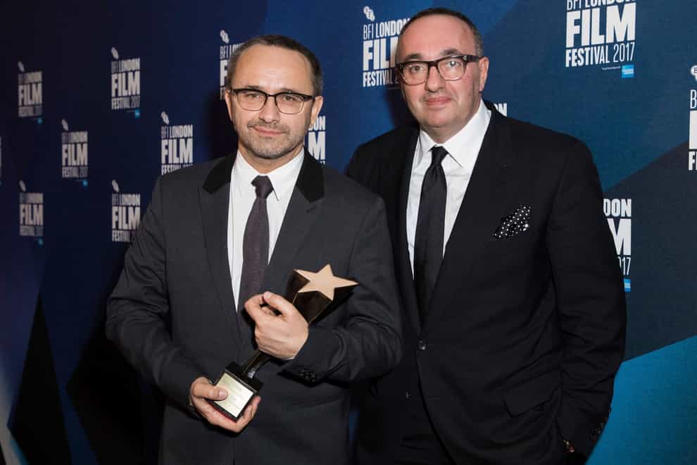 Directors Andrey Zvyagintsev and Alexander Rodnyansky, right, pose for photographers after receiving the Official Competition Best Film award for their film Loveless at the London Film Festival Awards in 2014 (Vianney Le Caer/Invision/AP)