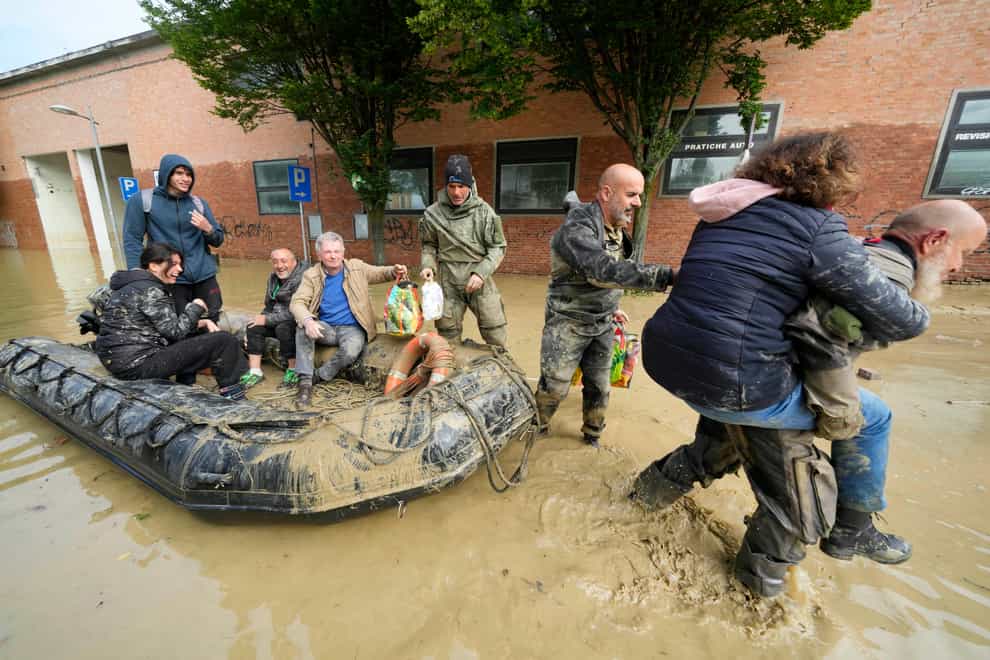 People are rescued in Faenza, Italy, after heavy rain brought flooding (AP Photo/Luca Bruno)