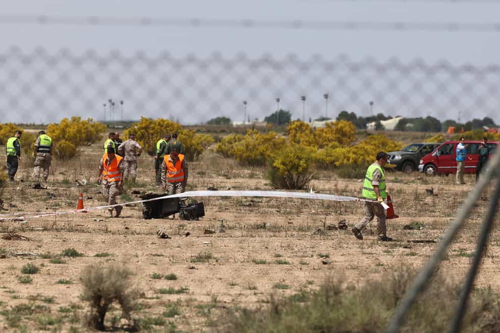 Emergency service members work in the area where an F-18 fighter jet crashed in Zaragoza (Europa Press via AP)