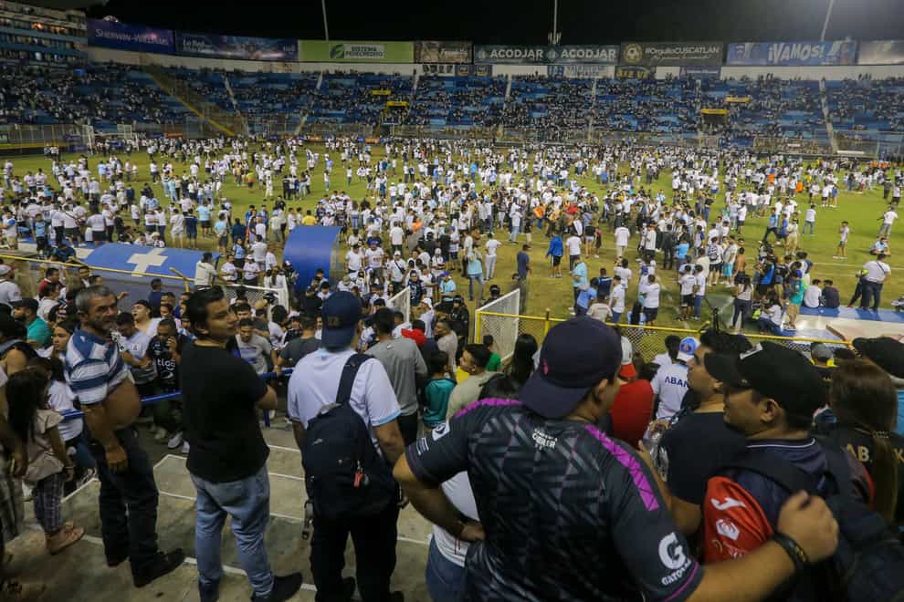 Fans take to the field of Cuscatlan stadium in San Salvador, El Salvador (Milton Flores/AP)
