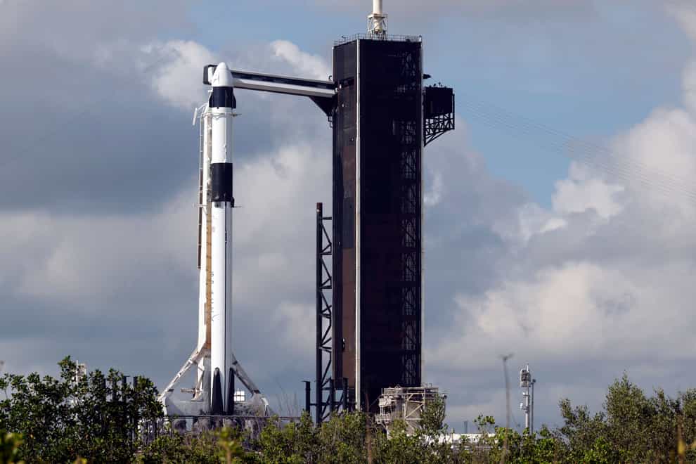 A SpaceX Falcon 9 rocket, with the Crew Dragon spacecraft, stands ready for launch (Terry Renna/AP)