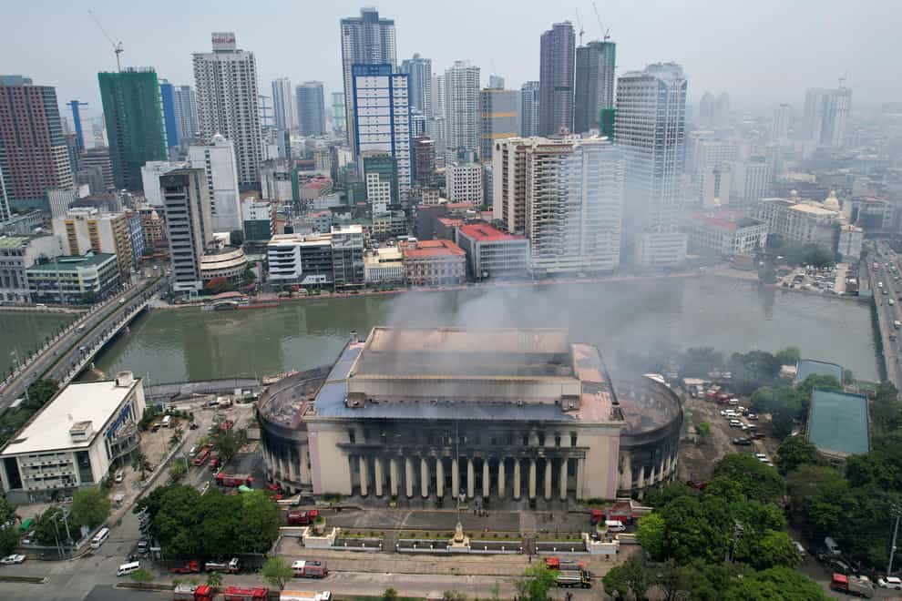 Smoke billows from the Manila Central Post Office (Aaron Favila/AP)