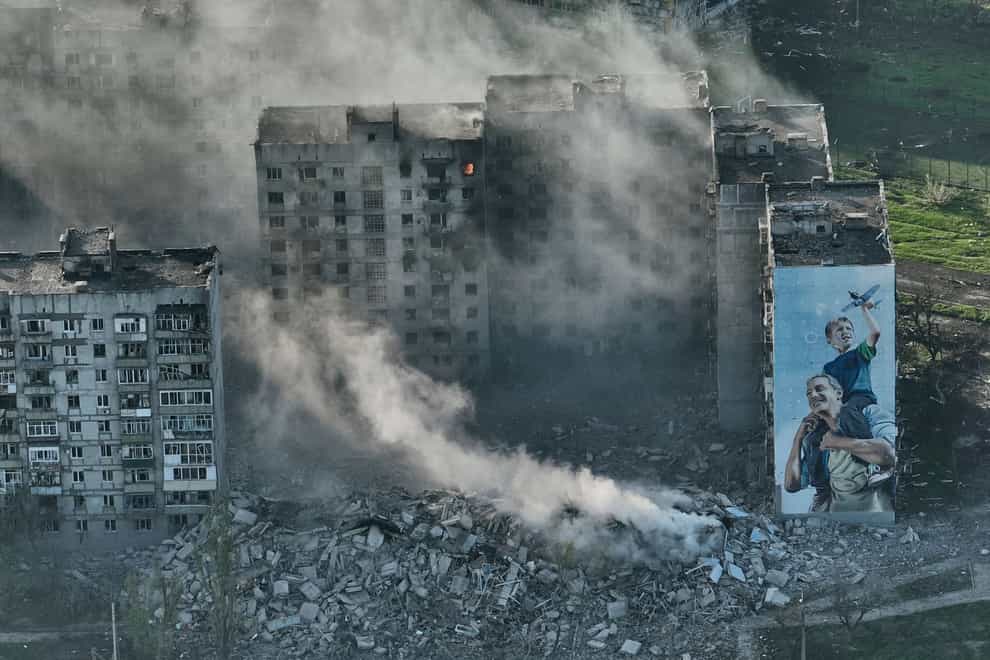 Smoke rises from a building in Bakhmut (Libkos,/AP)
