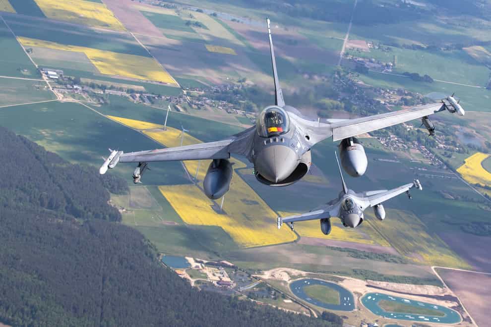 Romanian air force F-16 fighter jets take part in Nato’s Baltic Air Policing Mission in Lithuanian airspace on Monday (Mindaugas Kulbis/AP)