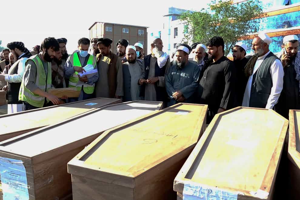 Afghan families receive bodies of their relatives who died while being smuggled into Bulgaria,(Afghanistan Foreign Ministry via AP)
