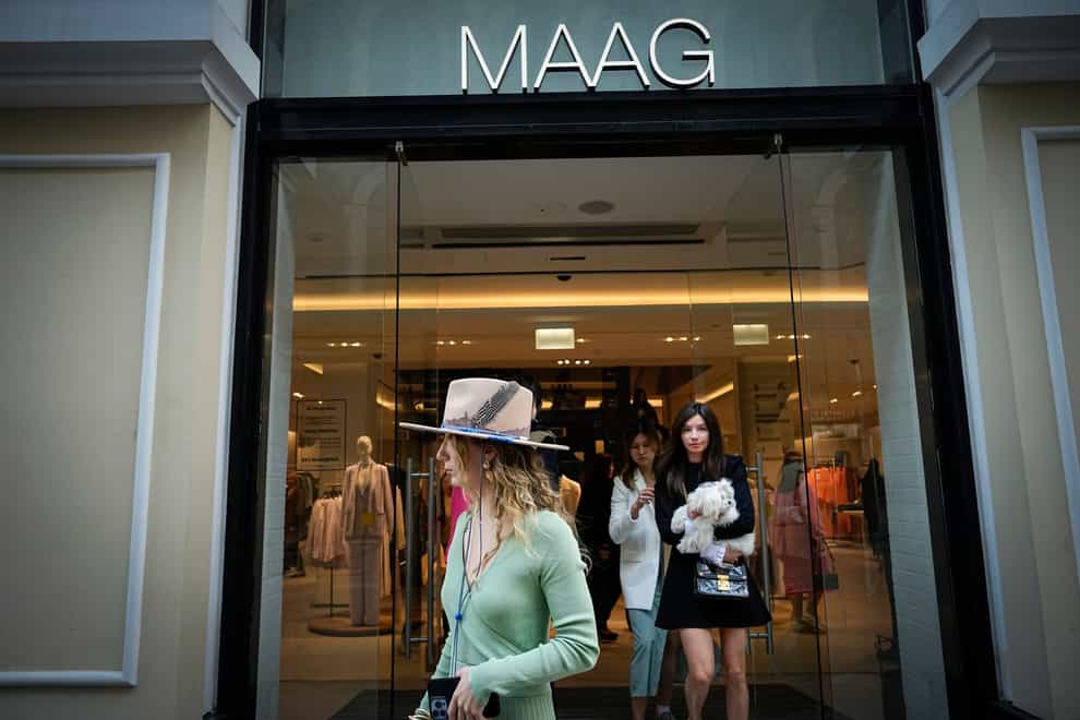 A woman exits Maag, a former Zara flagship store, in Moscow, Russia (Alexander Zemlianichenko/AP)