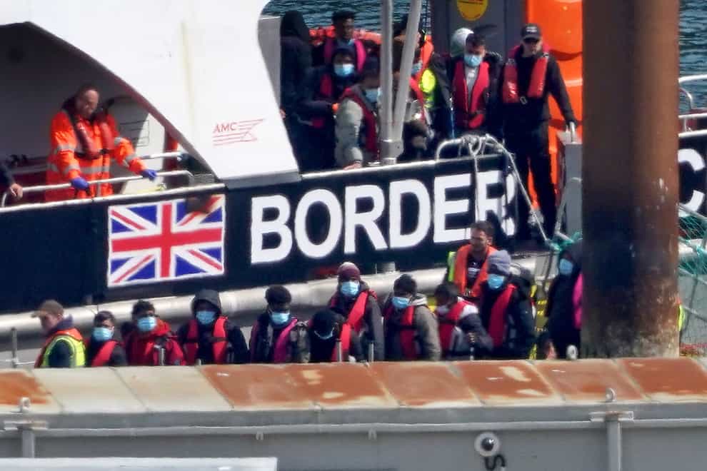 A group of people thought to be migrants are brought in to Dover (PA)