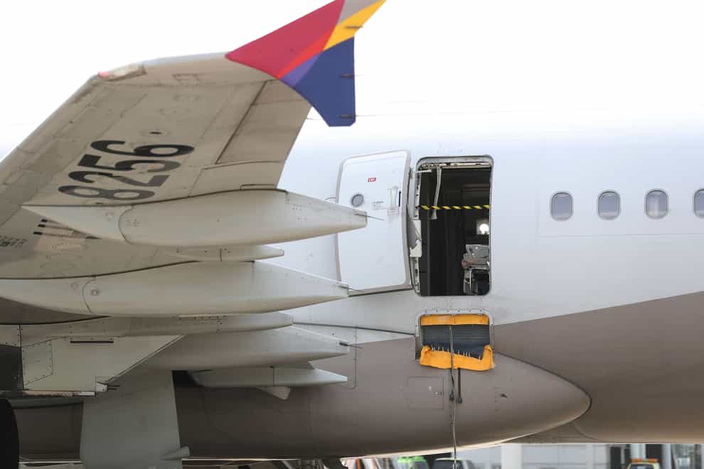 An Asiana Airlines plane is parked as one of the plane’s doors suddenly opened at Daegu International Airport in Daegu (Yonhap via AP)