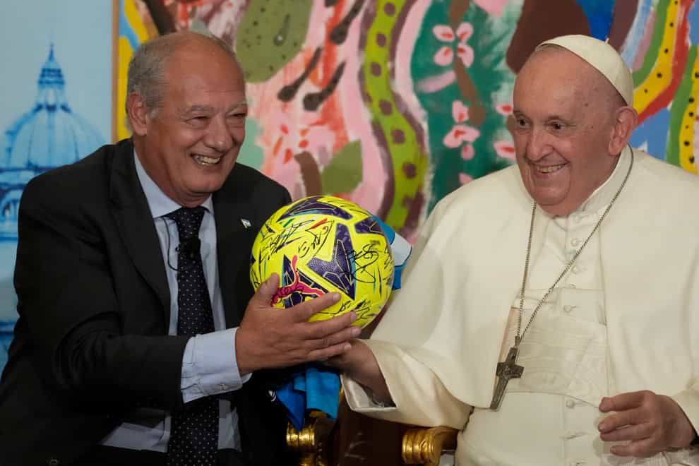 Pope Francis, flanked by Jose Maria del Corral, president of Scholas Occurrentes, holds a soccer ball he was gifted as they attend the world’s first meeting of the ‘Educational Eco-Cities’ promoted by the ‘Scholas Occurrentes’, at the Vatican (AP)