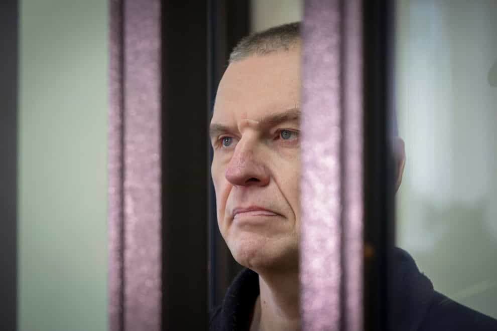 Journalist Andrzej Poczobut stands in a defendants’ cage during a court session in Grodno, Belarus, in January 2023 (Leonid Shcheglov/Pool via AP/PA)