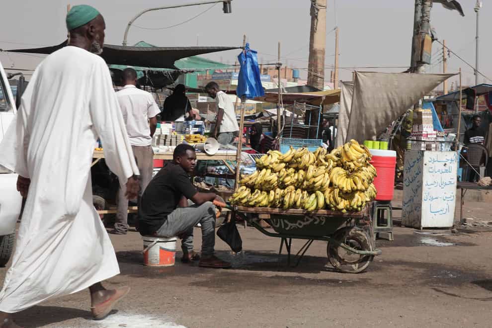 A man sells bananas at a market during a ceasefire in Khartoum, Sudan (Marwan Ali/AP)