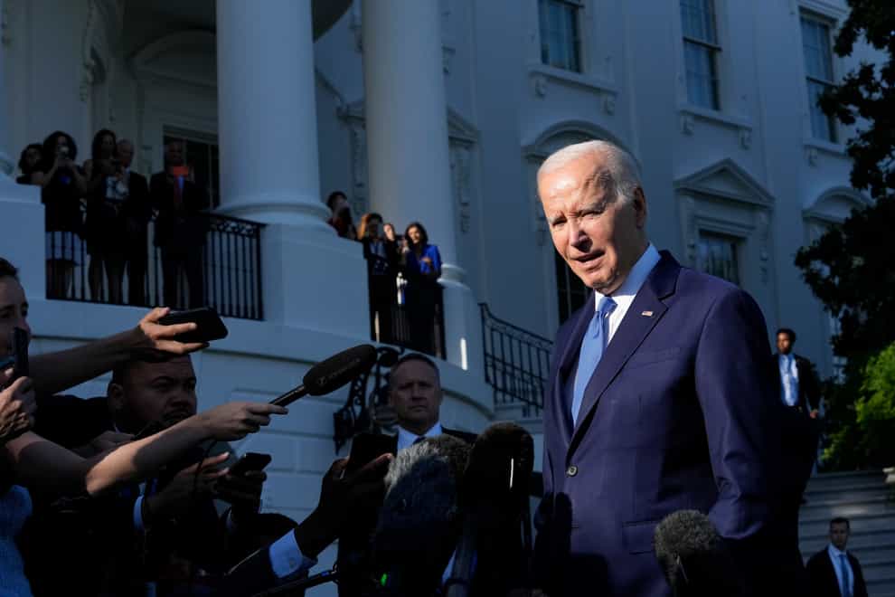 US President Joe Biden talks to reporters before boarding Marine One on the South Lawn of the White House in Washington on Friday, May 26, 2023, as he heads to Camp David (Susan Walsh/AP/PA)