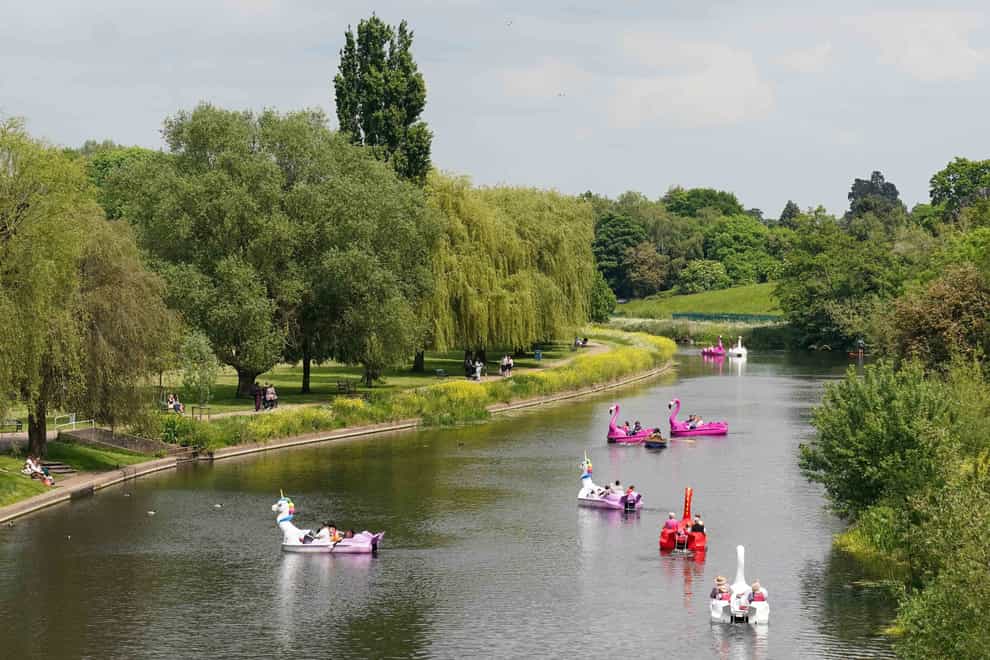 People enjoying the warm weather along the river Avon in Warwick on Sunday (Jacob King/PA)