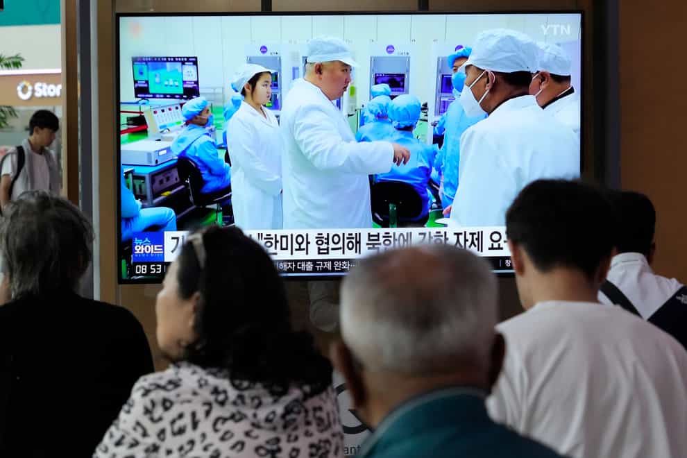 A TV screen shows a file image of North Korean leader Kim Jong Un, third from left, during a news programme at the Seoul Railway Station in Seoul, South Korea, on Monday, May 29, 2023 (Ahn Young-joon/AP/PA)