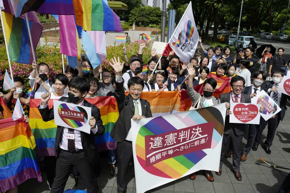 Lawyers and supporters celebrate following the ruling (Kyodo News/AP)
