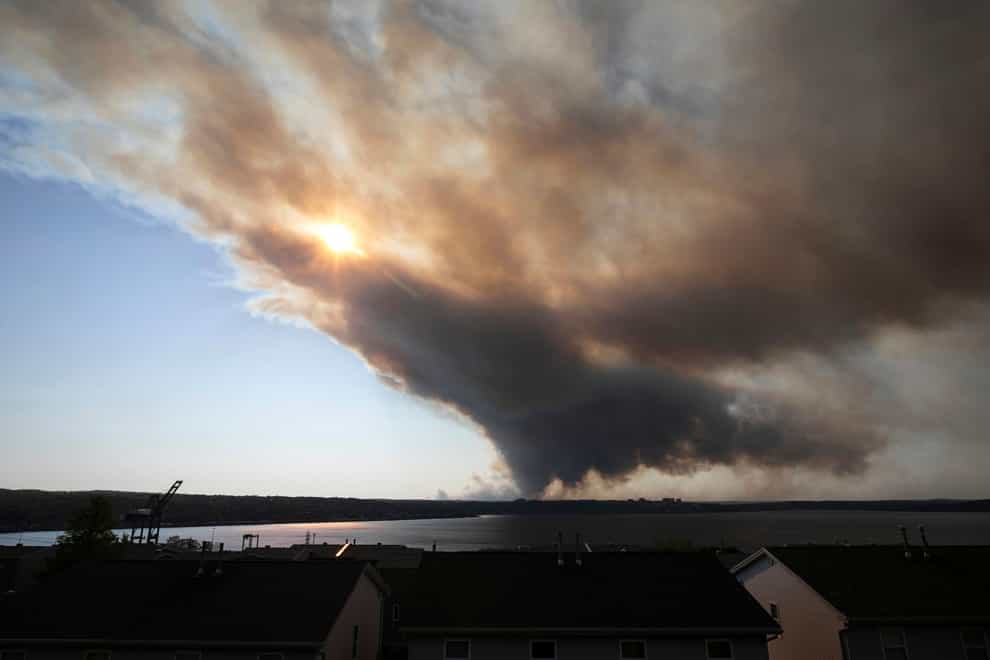 Thick plumes of heavy smoke fill the Halifax sky as an out-of-control fire in a suburban community quickly spread (The Canadian Press via AP)