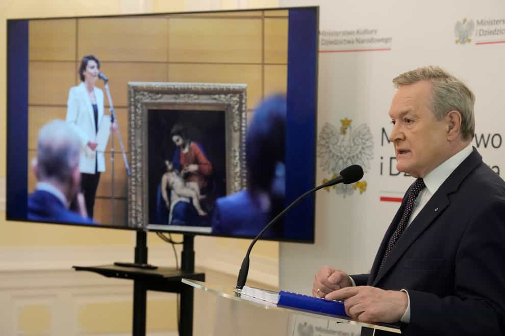 Poland’s culture minister, Piotr Glinski, right, adresses the media during a press conference in Warsaw, Poland, saying that a precious 16th century painting has been returned to Poland (Czarek Sokolowski/AP/PA)