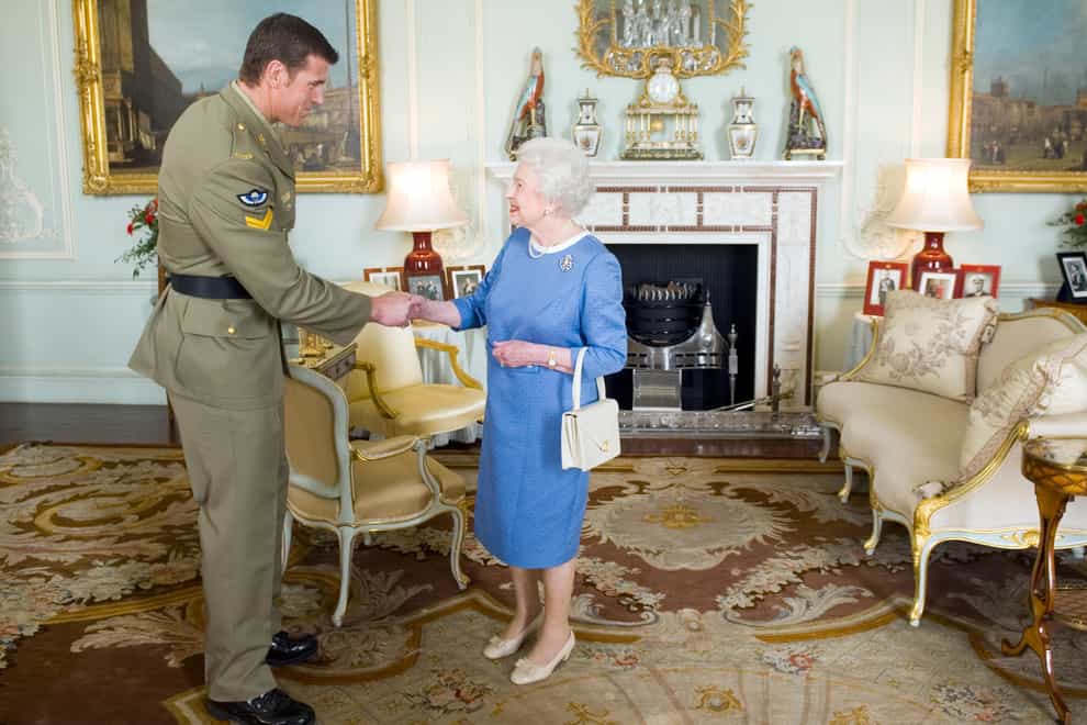 The late Queen greets Ben Roberts-Smith at Buckingham Palace in 2011 (PA)