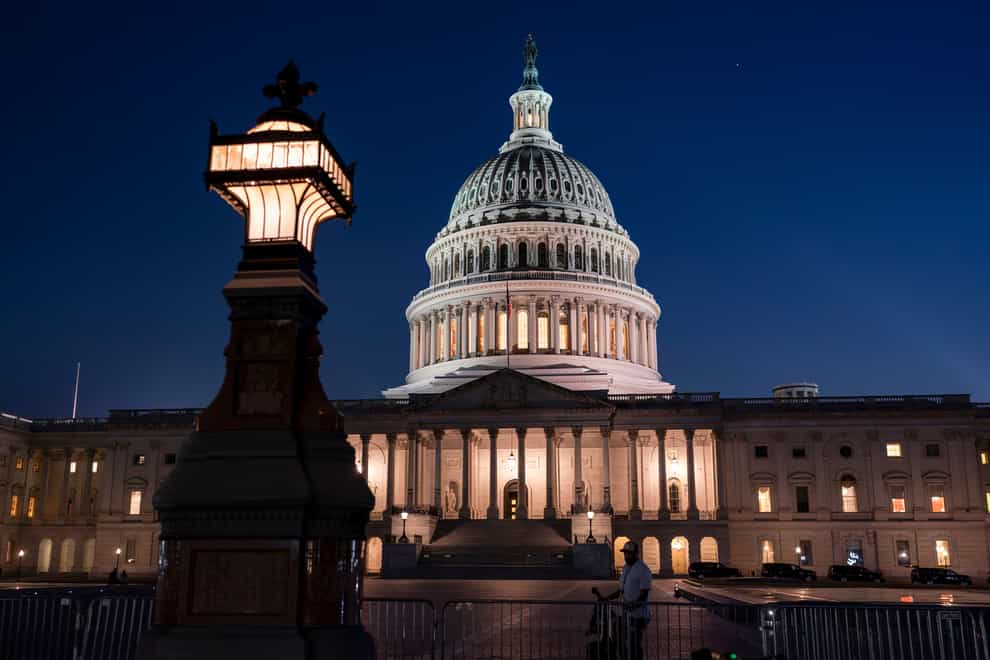 Days away from a default crisis, the Capitol is illuminated as the Senate works into the night to finish votes on amendments on the big debt ceiling and budget cuts package, at the Capitol in Washington, Thursday evening, June 1, 2023. (AP Photo/J. Scott Applewhite)