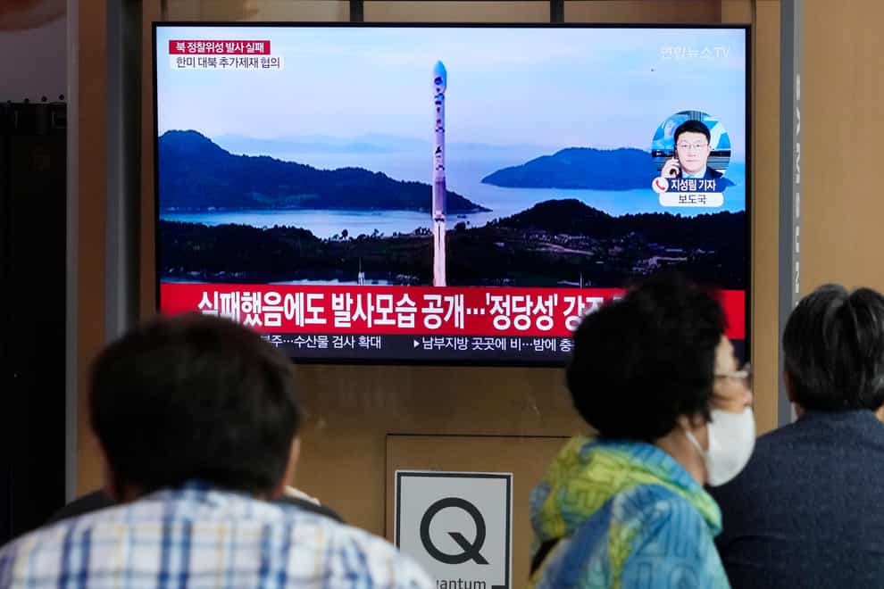 A TV screen in Seoul shows an image of North Korea’s rocket launch (AP)